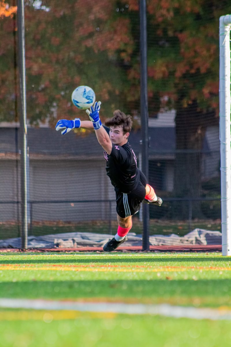 Hillers Soccer goalie, Cole Carberry '26 makes a diving save.