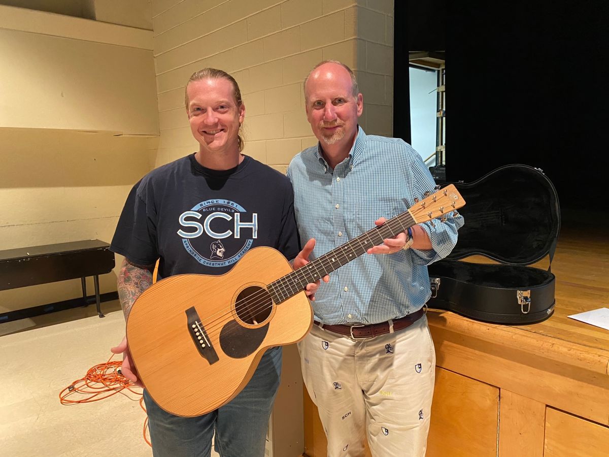 Josh Mattingly poses with Dr. Druggan after gifting him the guitar at the end-of-year faculty meeting. Photo courtesy of Josh Mattingly 