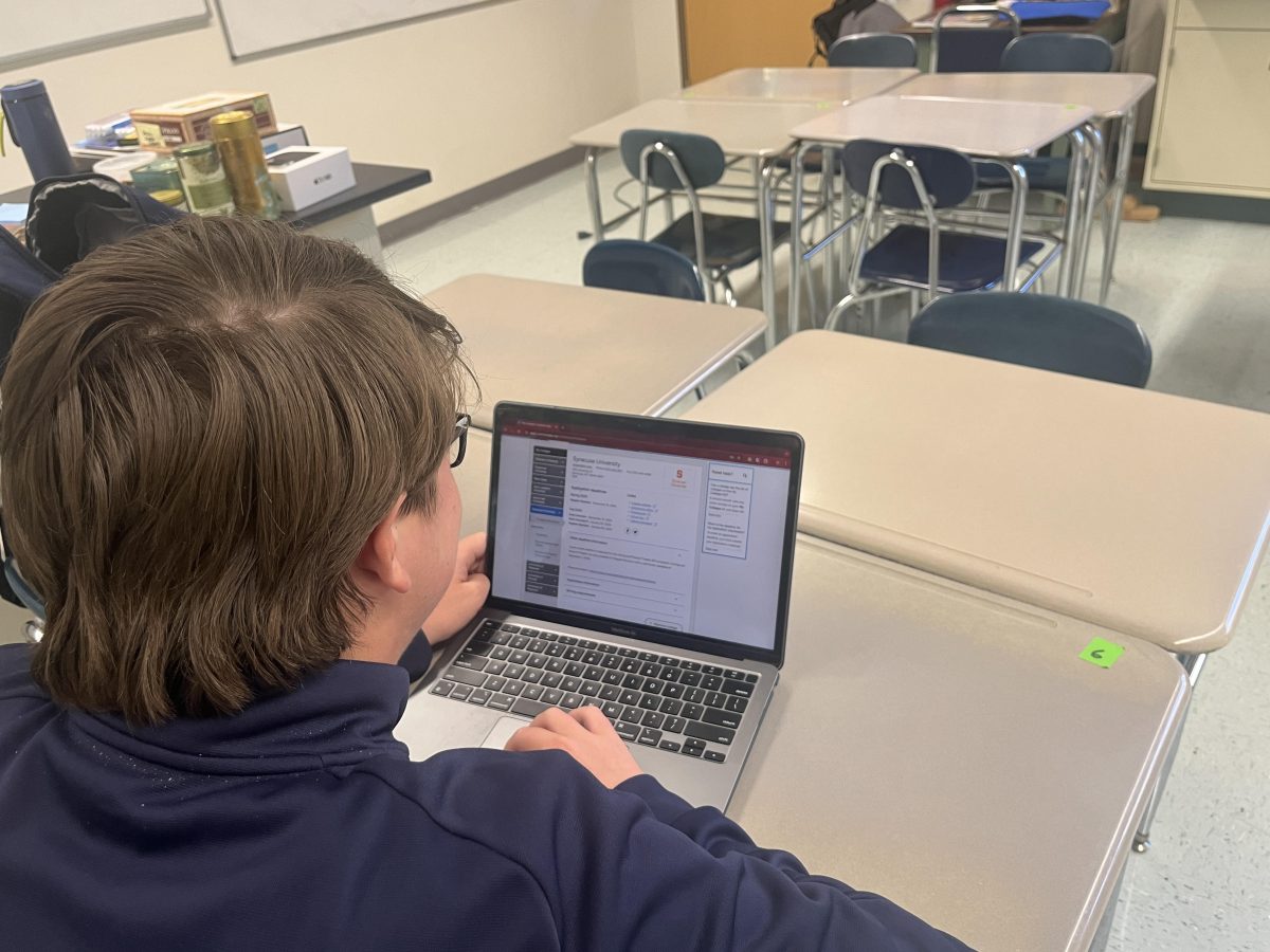 Senior Brendan Flatow works on his early decision application for Syracuse University after class.