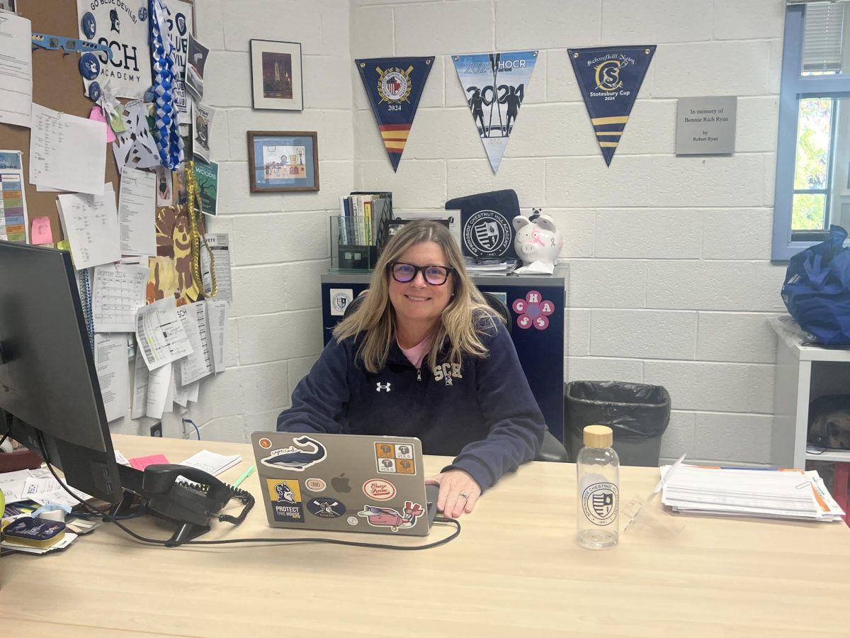 Mrs Keough sits down at her desk, hard at work