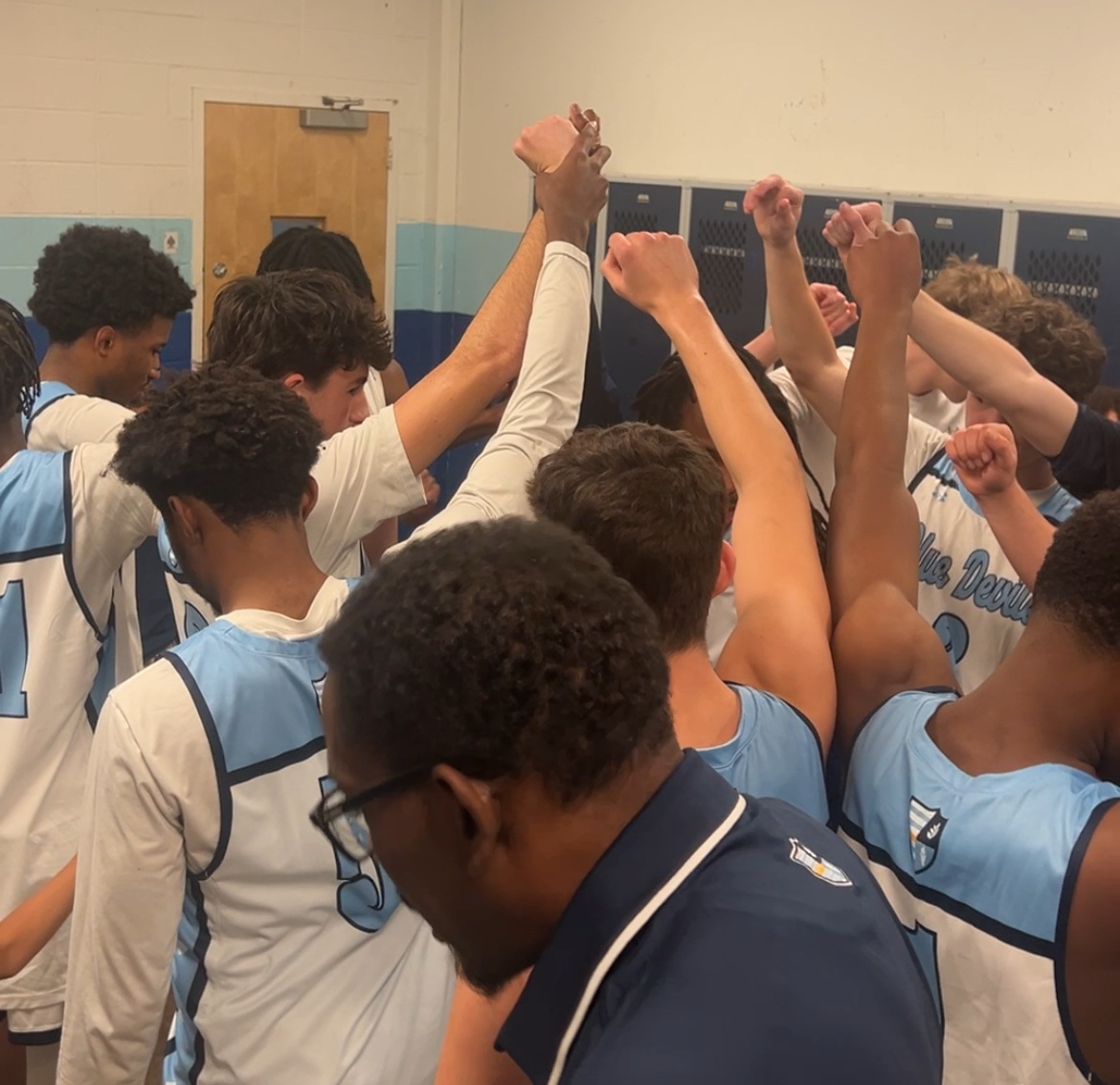 Devils meet in the locker room after historic 100th win.