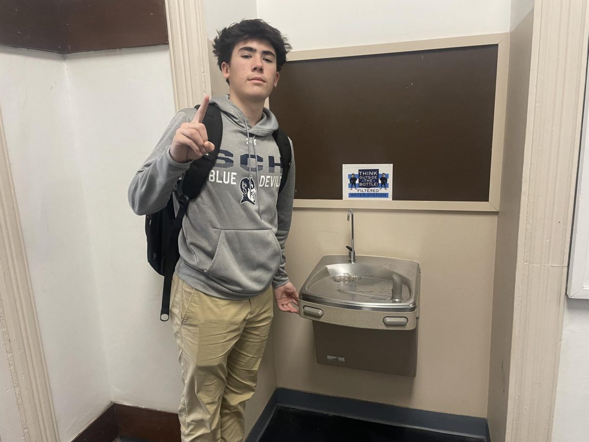 Braydon Trunfio stands beside Norcini's water fountain 