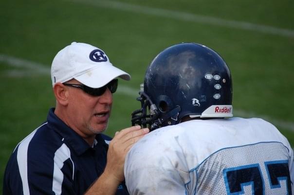 Coach Ed talking to a CHA Football Player