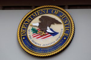 The seal of the United States Department of Justice is seen on the building exterior of the United States Attorney's Office of the Southern District of New York in Manhattan, New York City, U.S., August 17, 2020. REUTERS/Andrew Kelly