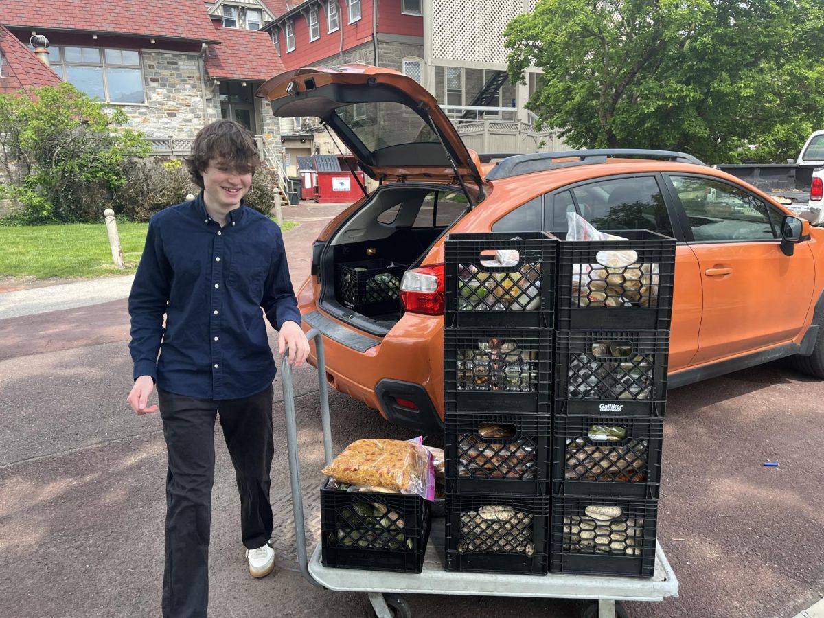 Judah Meyer '26 loads excess food from SCH cafeteria into car for donation