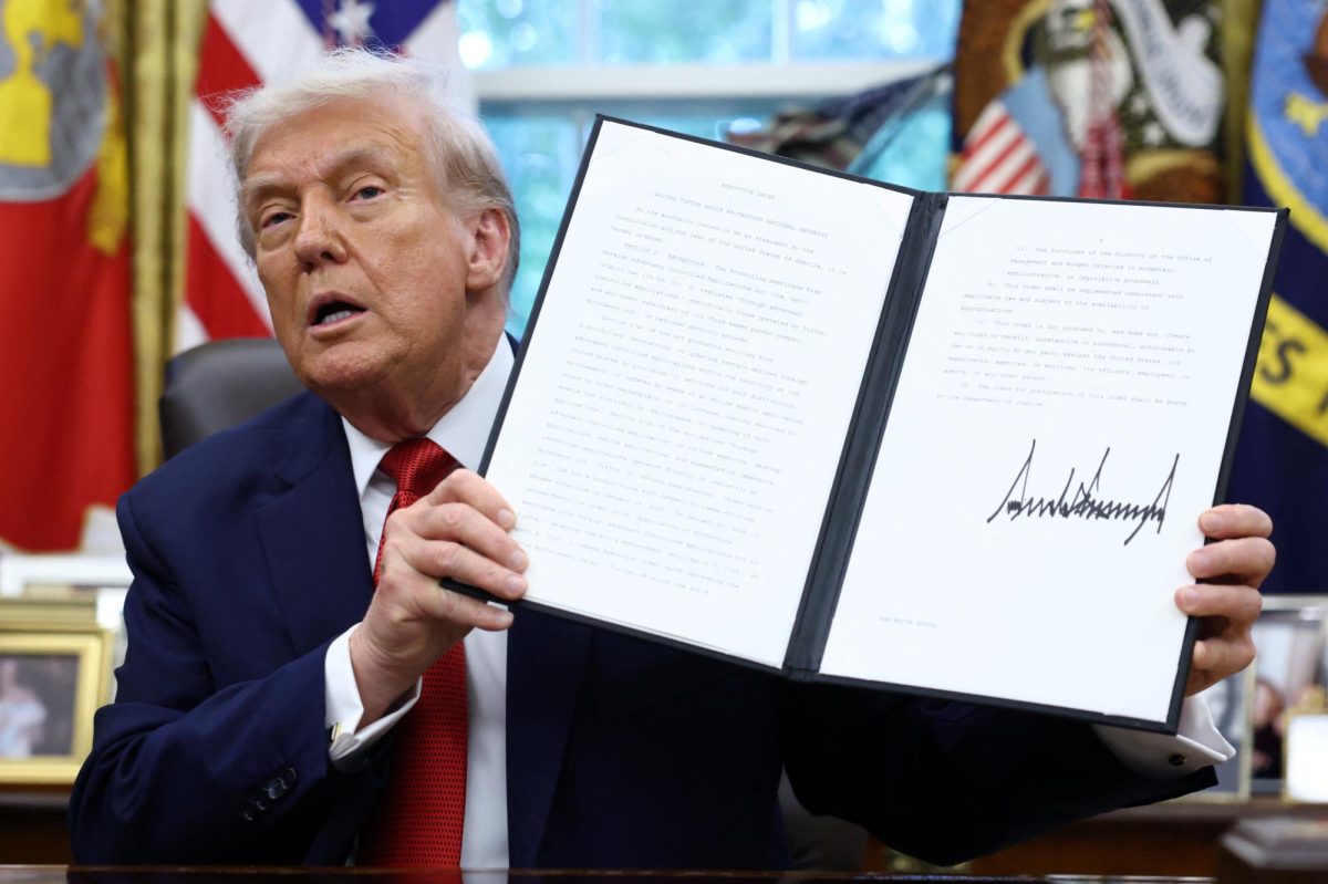 U.S. President Donald Trump shows a signed executive order on a deal that would divest TikTok's U.S. operations from ByteDance from its Chinese owner ByteDance, at the White House in Washington, D.C., U.S., September 25, 2025. REUTERS/Kevin Lamarque
