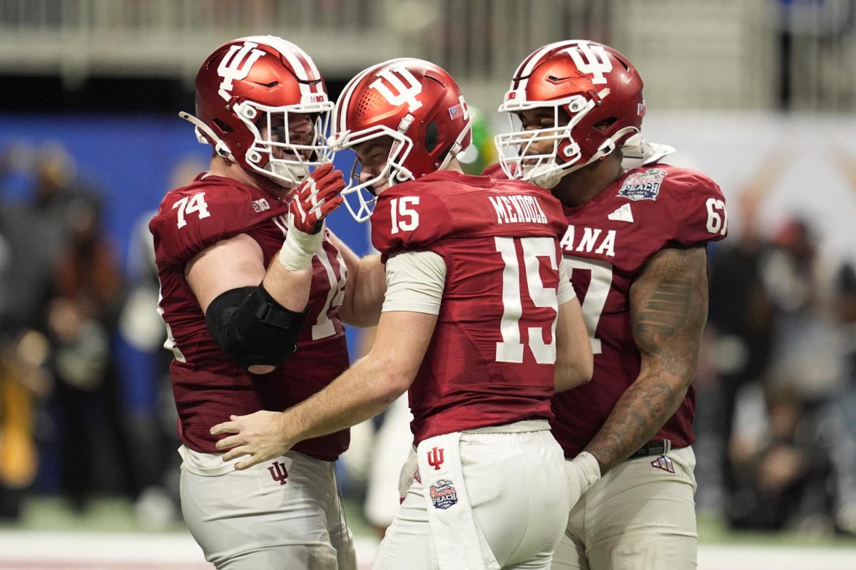 Jan 9, 2026; Atlanta, GA, USA; Indiana Hoosiers quarterback Fernando Mendoza (15) celebrates with Indiana Hoosiers offensive lineman Bray Lynch (74) after a touchdown against the Oregon Ducks during the fourth quarter the 2025 Peach Bowl and semifinal game of the College Football Playoff at Mercedes-Benz Stadium. Mandatory Credit: Dale Zanine-Imagn Images