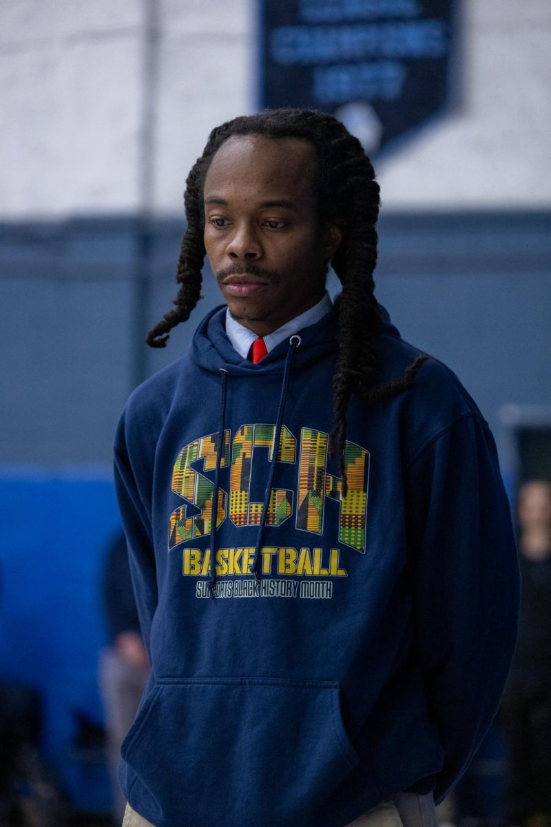 Coach Jules waits before tip-off.