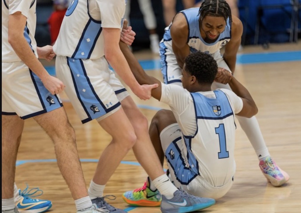 Jules Sanders '26 getting helped up after getting fouled on a play.