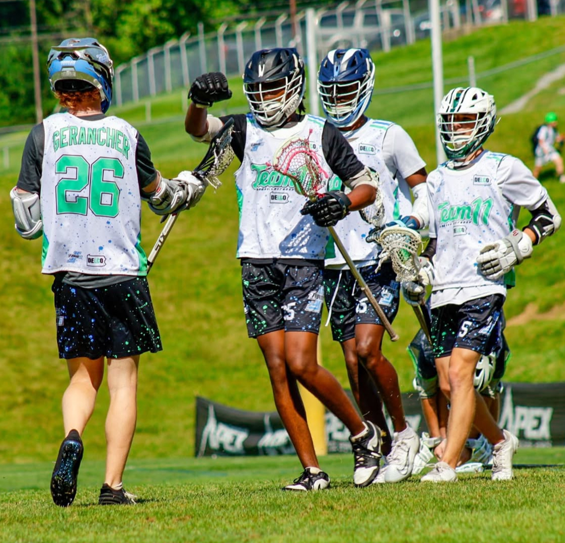 Ken Vaughan with Team 11 club teammates celebrating after a goal.