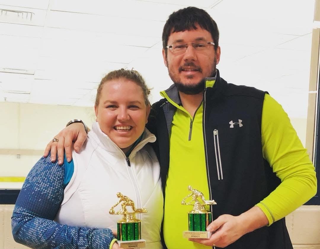 Derrick Keister posing with his wife after they both win a Curling competition | Derrick Keister 